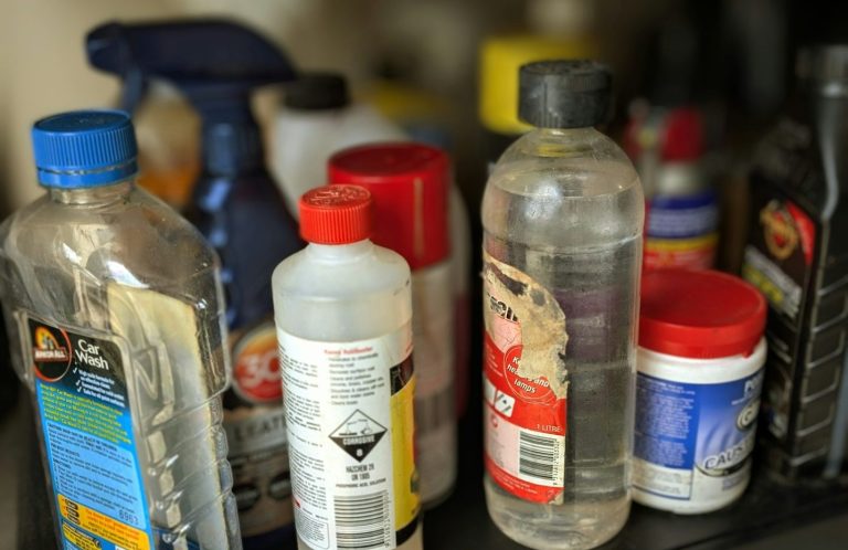 COSHH Training Bottles of cleaning products and chemicals on a shelf.